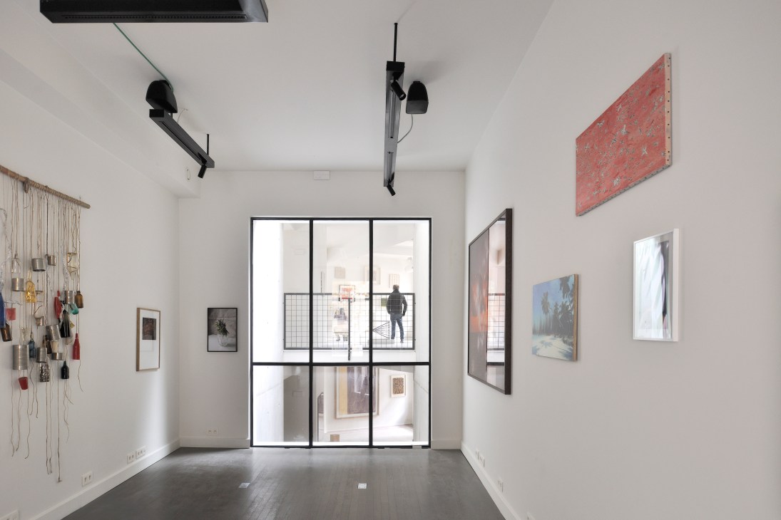 Cloud Seven gallery interior showing white walls with framed artworks and modern lighting fixtures
