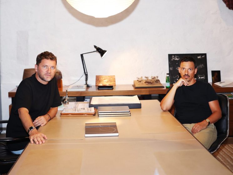 Karl Fournier and Olivier Marty of Studio KO sitting at a conference table in their modern office workspace