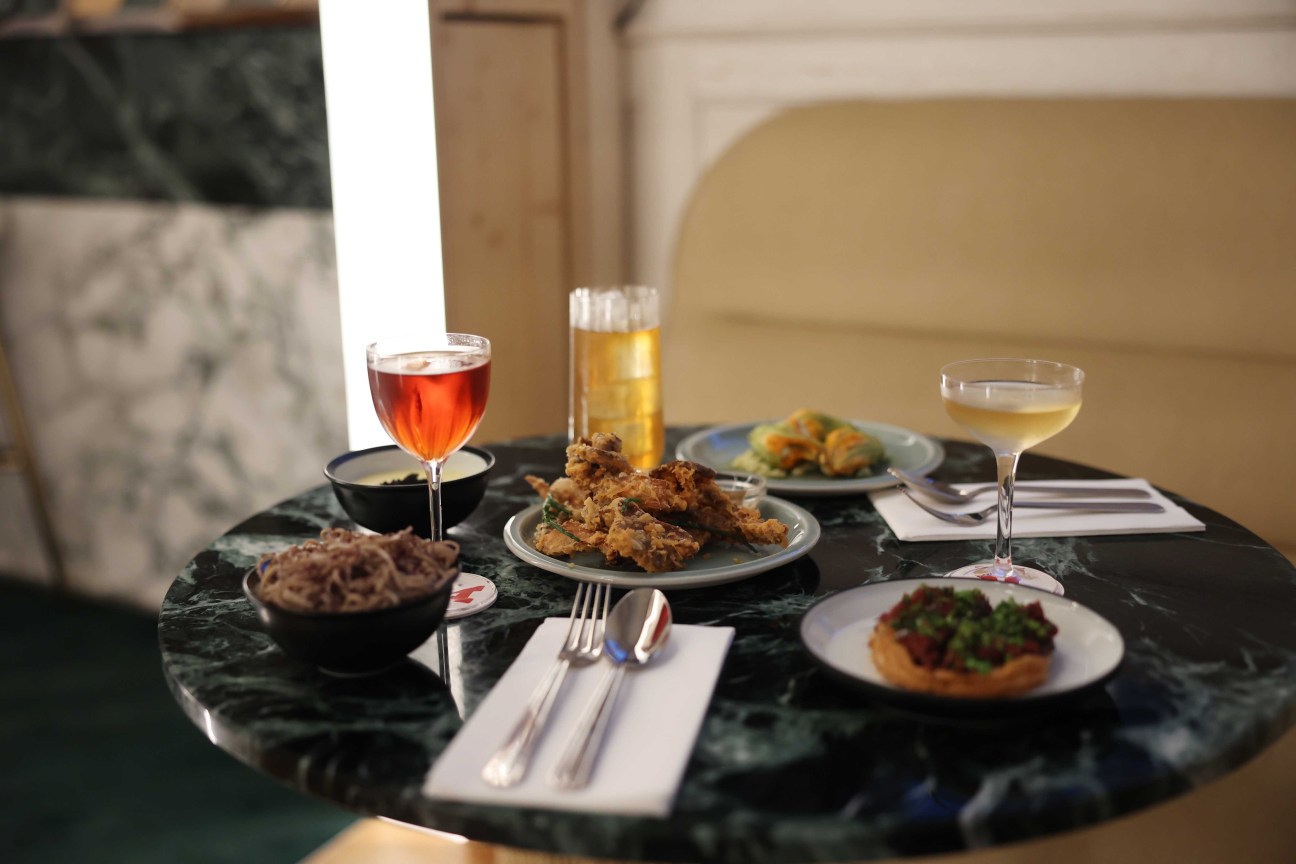 Bartender preparing classic cocktails with modern twists at one of Cravan's three bars