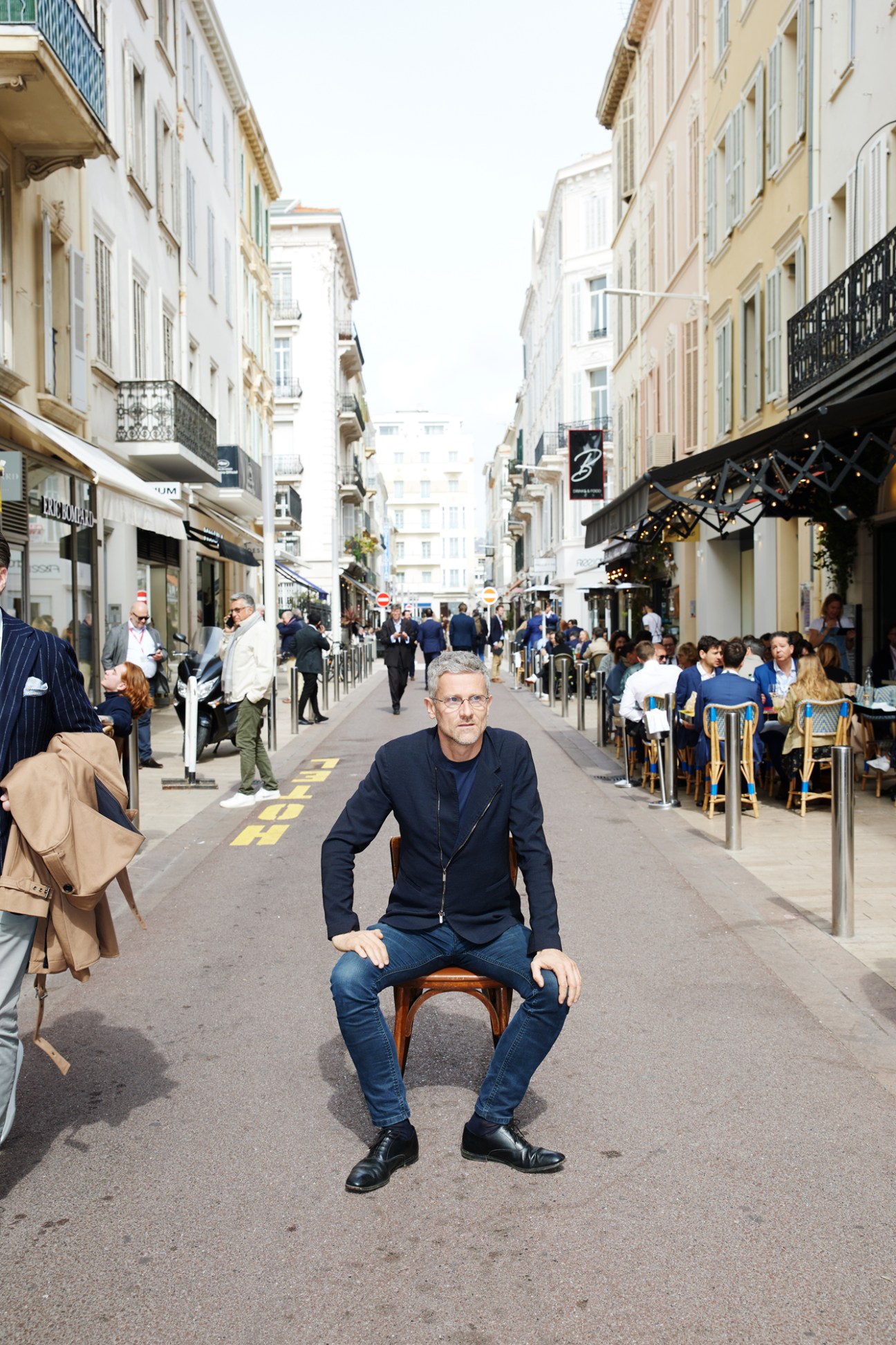 Carlo Ratti sitting on chair in pedestrian street during Mipim conference in Cannes