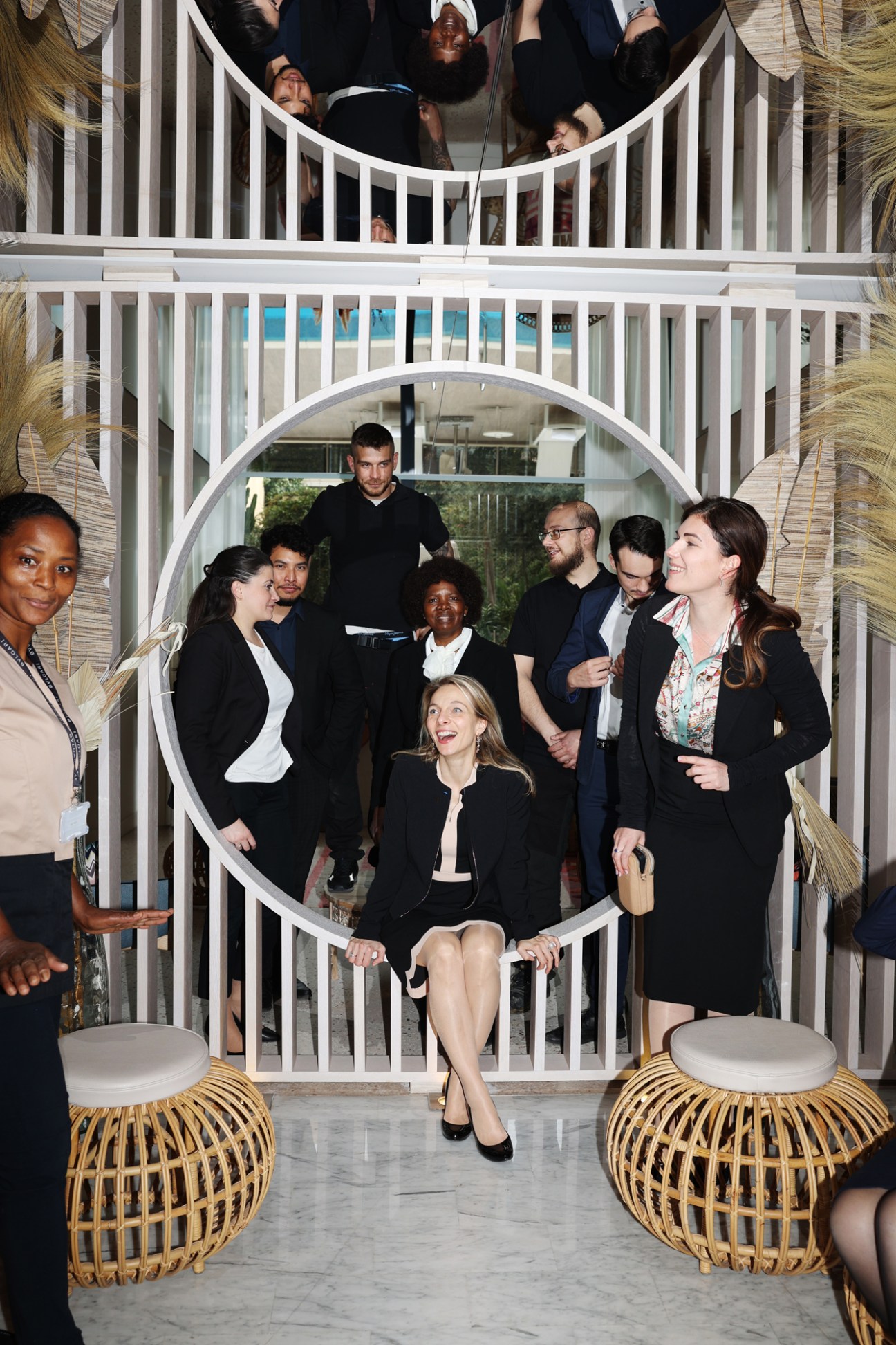 Maud Bailly and Accor team members posing in modern white circular architectural structure at Mipim conference
