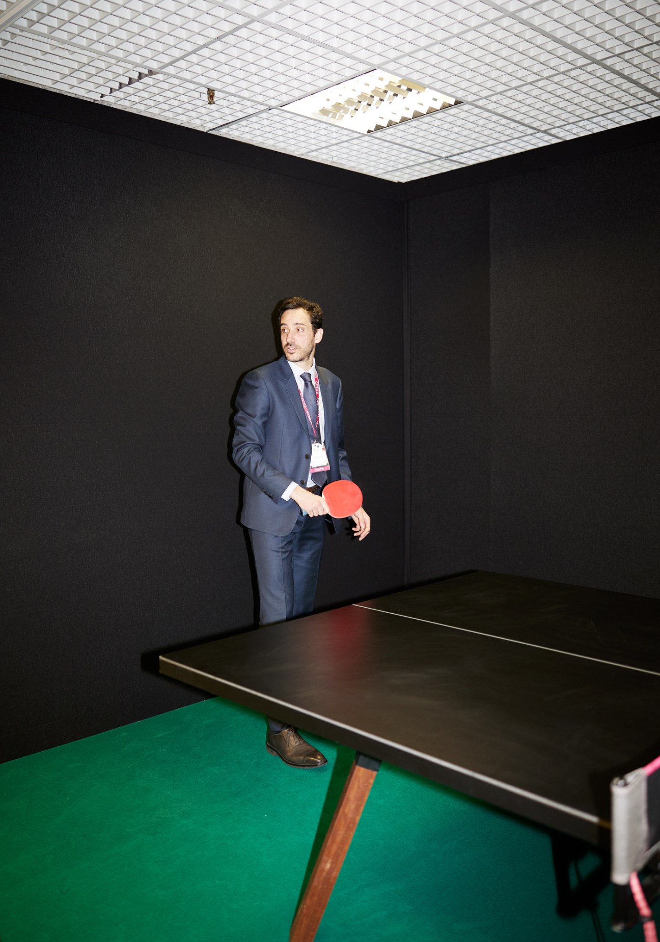 Man in business suit holding table tennis paddle at Mipim property conference
