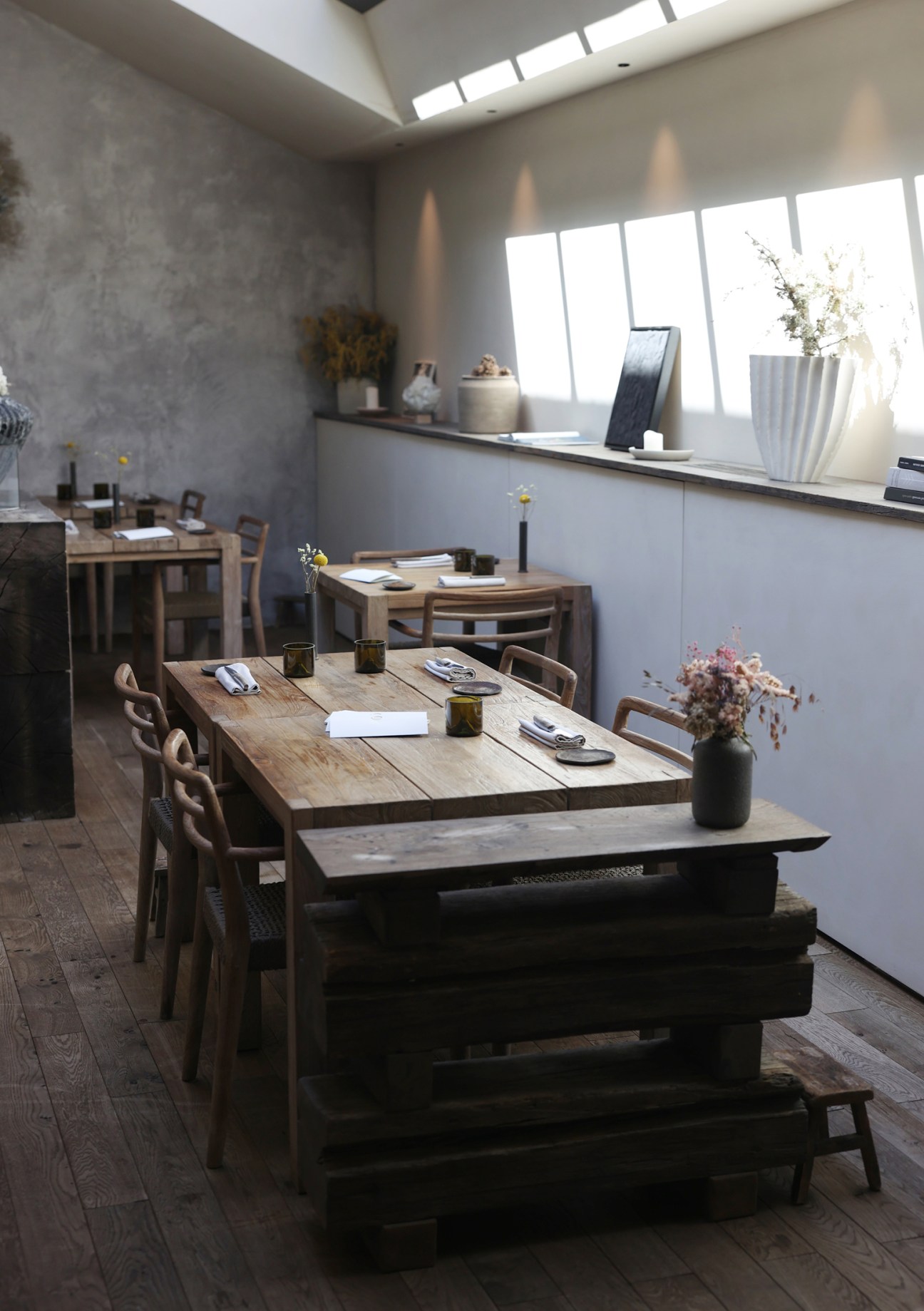 Minimalist dining room interior at Cibo restaurant with wooden tables and Japanese-inspired design elements