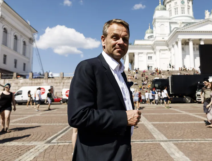Jan Vapaavuori, Mayor of Helsinki, standing outdoors in a dark suit with white cathedral building behind him