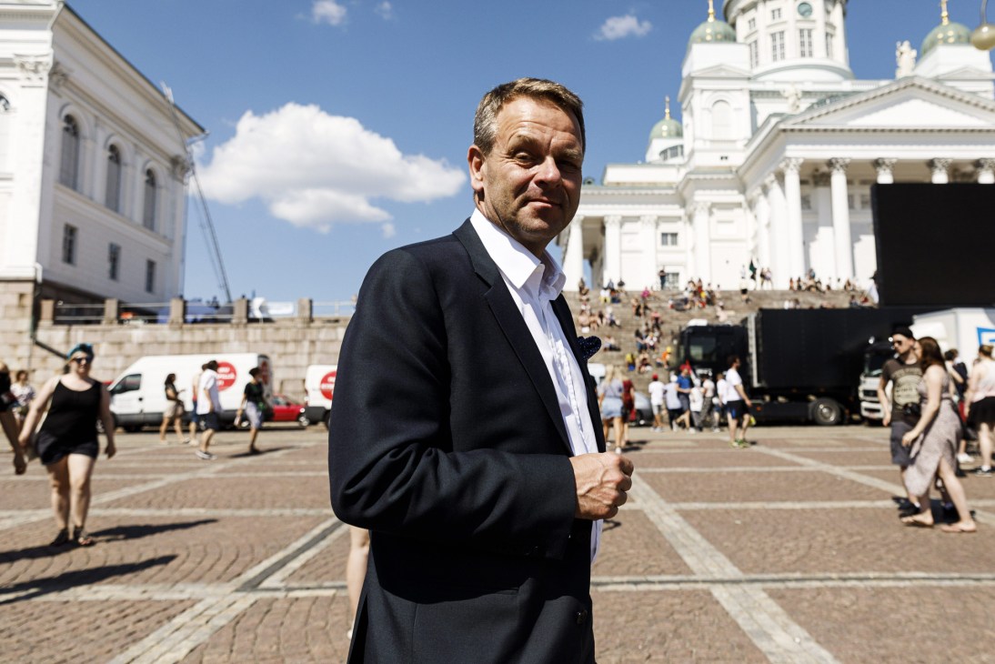 Jan Vapaavuori, Mayor of Helsinki, standing outdoors in a dark suit with white cathedral building behind him