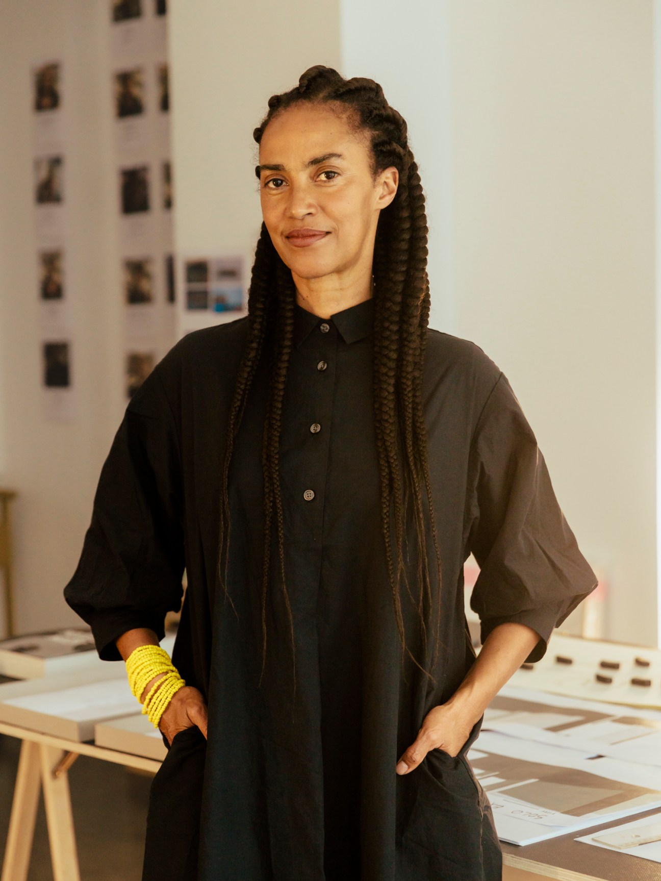 Portrait of artist Grada Kilomba in her studio wearing a black shirt.