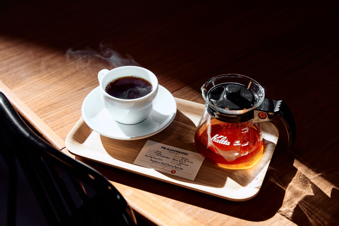 Interior view of Fuglen café showing wooden furniture, vintage décor and cosy seating area