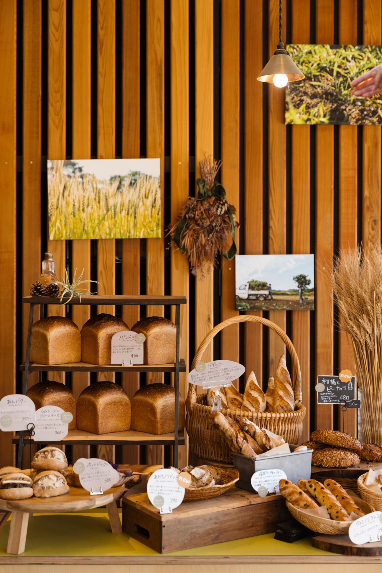 Interior of Lanka bakery showing shelves of fresh bread loaves and baguettes in wicker baskets with price tags