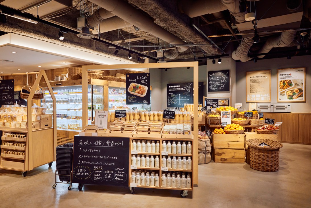 Bento lunches and fresh produce displayed in a modern Japanese retail store
