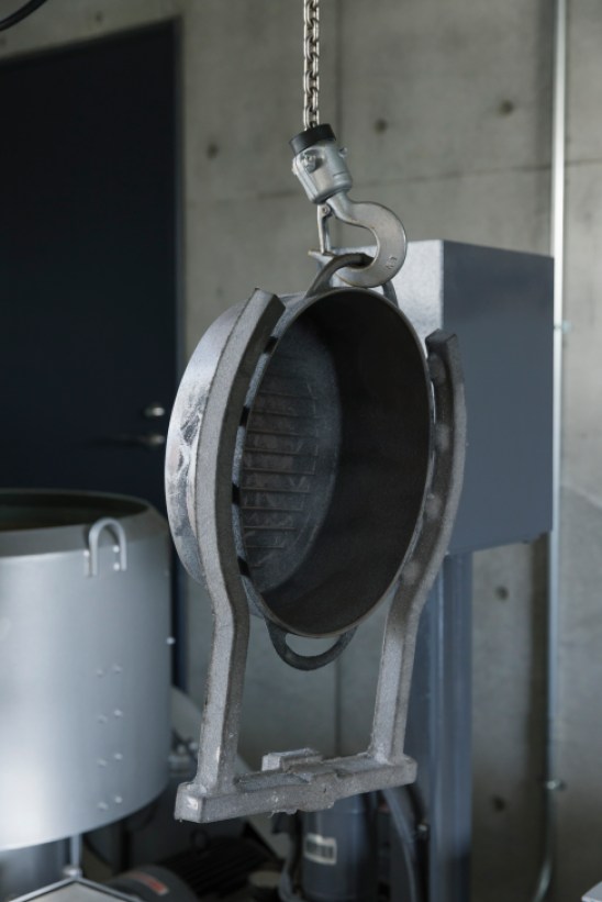 Cast iron pot being manufactured in the foundry, showing the precision machining process