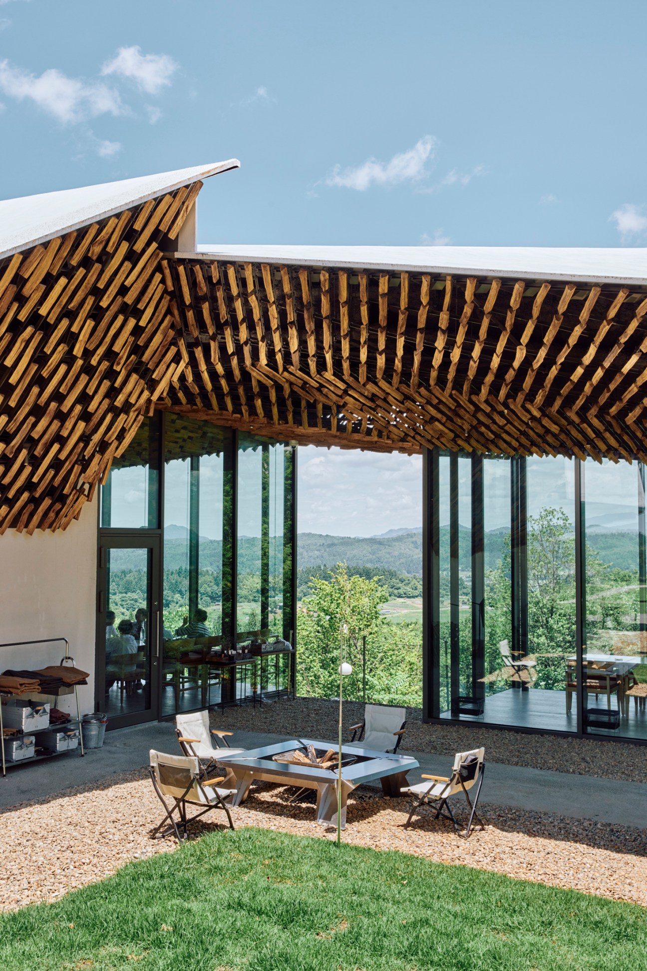 Snow Peak outdoor chairs arranged around a metal brazier fire pit