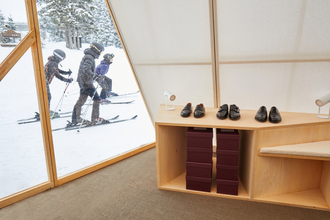 Close-up of John Lobb installation construction showing timber frame inspired by wooden shoe lasts and polycarbonate cladding