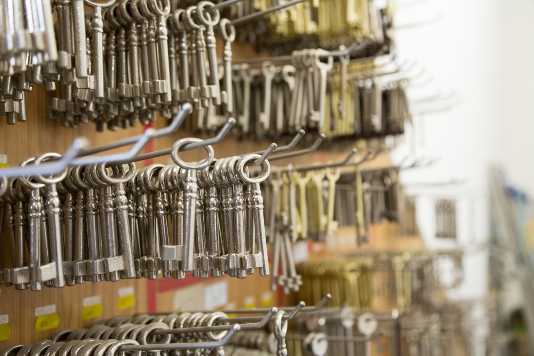 Rows of metal keys hanging on display hooks at Ferramenta Brugnara hardware shop