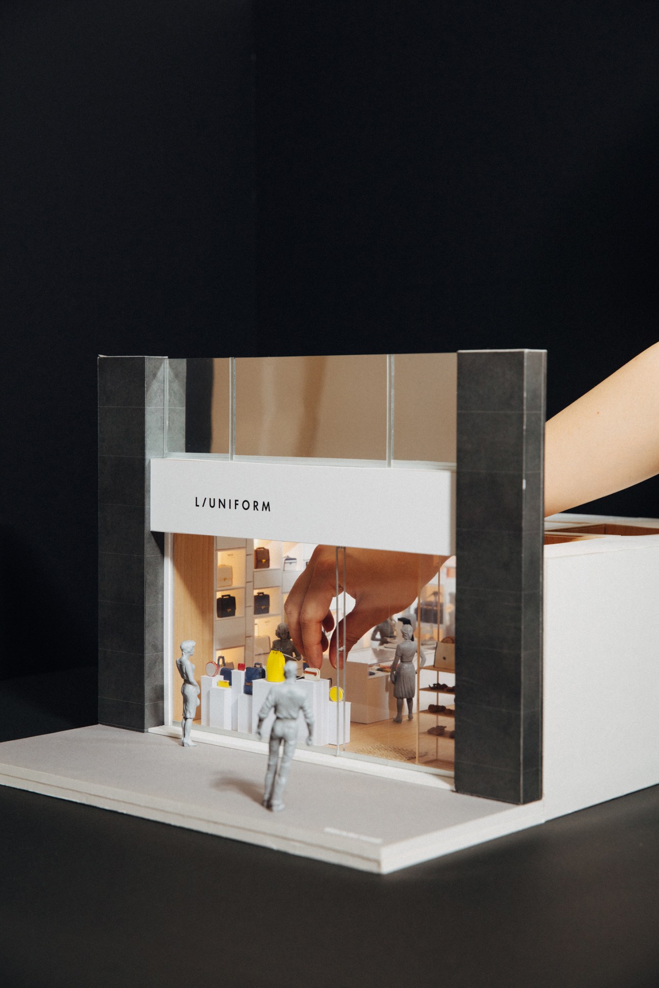 Detailed scale model of L/Uniform store interior with miniature fixtures, bags, and figurines
