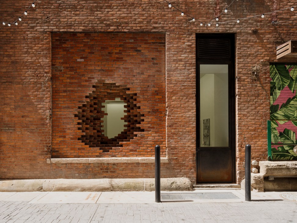 Interior view of the Library Street Collective gallery space with brick walls and contemporary art