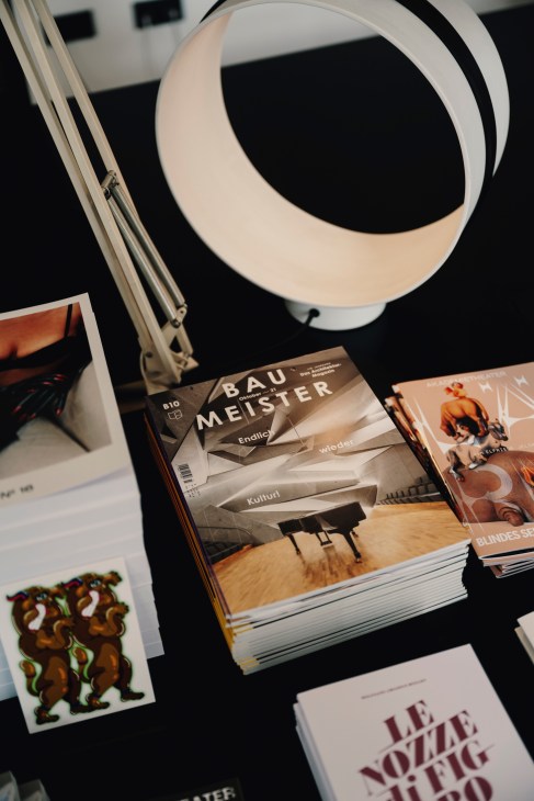 Baumeister architecture magazine with bold typographic cover displayed under a modern desk lamp