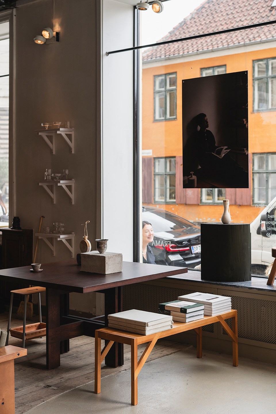 Interior view of Frama's main store on Fredericiagade showing wooden shelves, furniture displays, and large windows