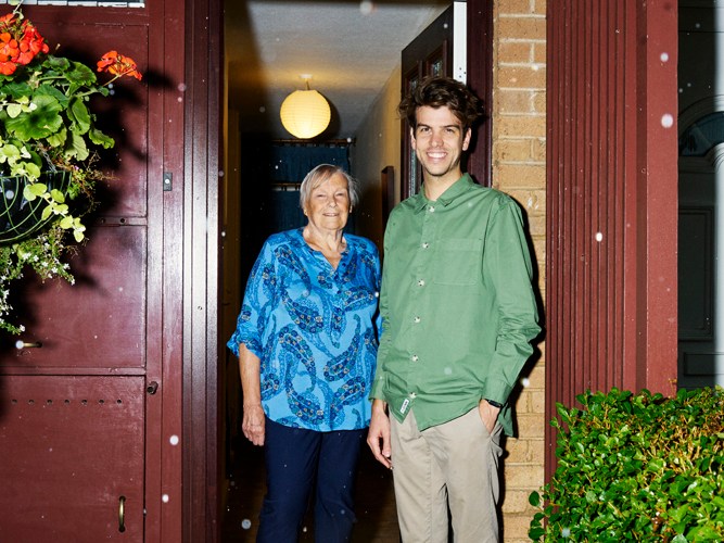 Pauline Ikin and a young man stand in the doorway of her Milton Keynes home.