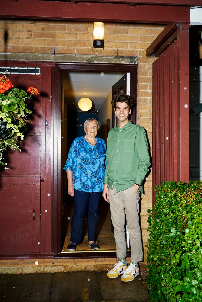 Pauline Ikin and a young man stand in the doorway of her Milton Keynes home.