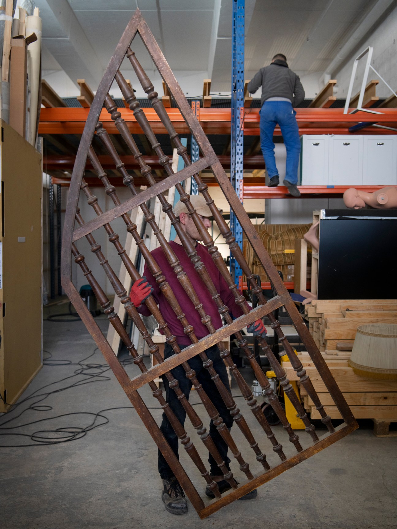 Triangular wooden frame holding turned wooden spindles and balusters in warehouse storage