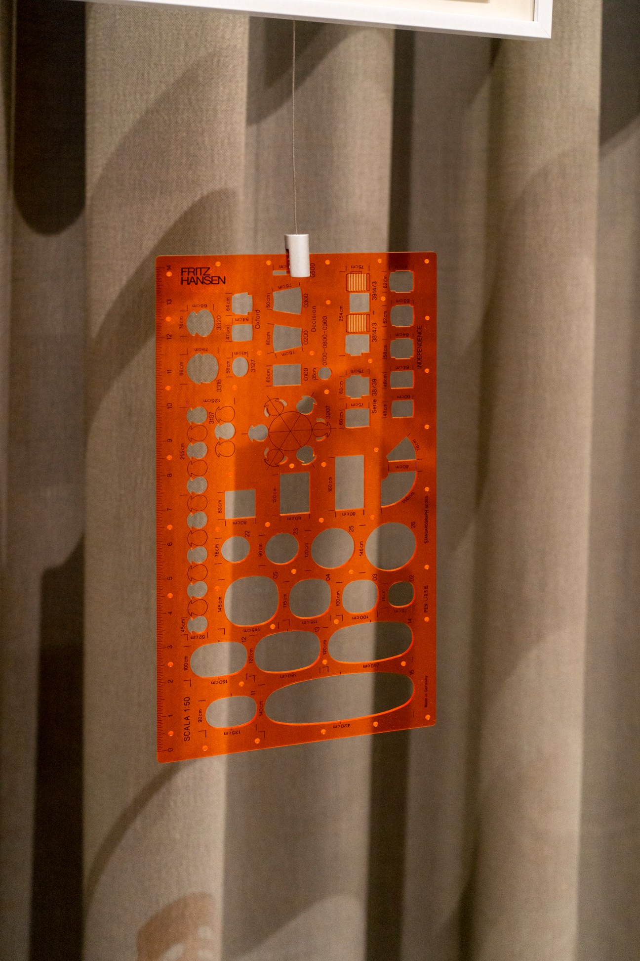 Orange template with various geometric cutout shapes including circles, squares, rectangles and ovals