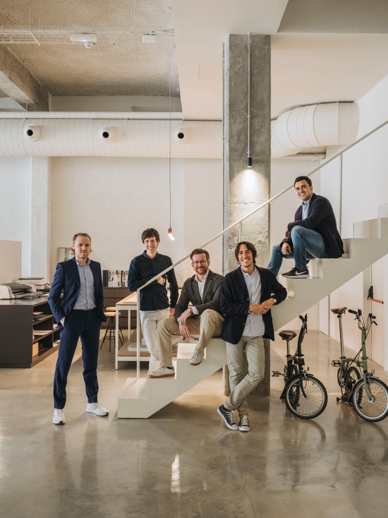 The five partners and team members of Mesura architecture studio posing in their Barcelona office.