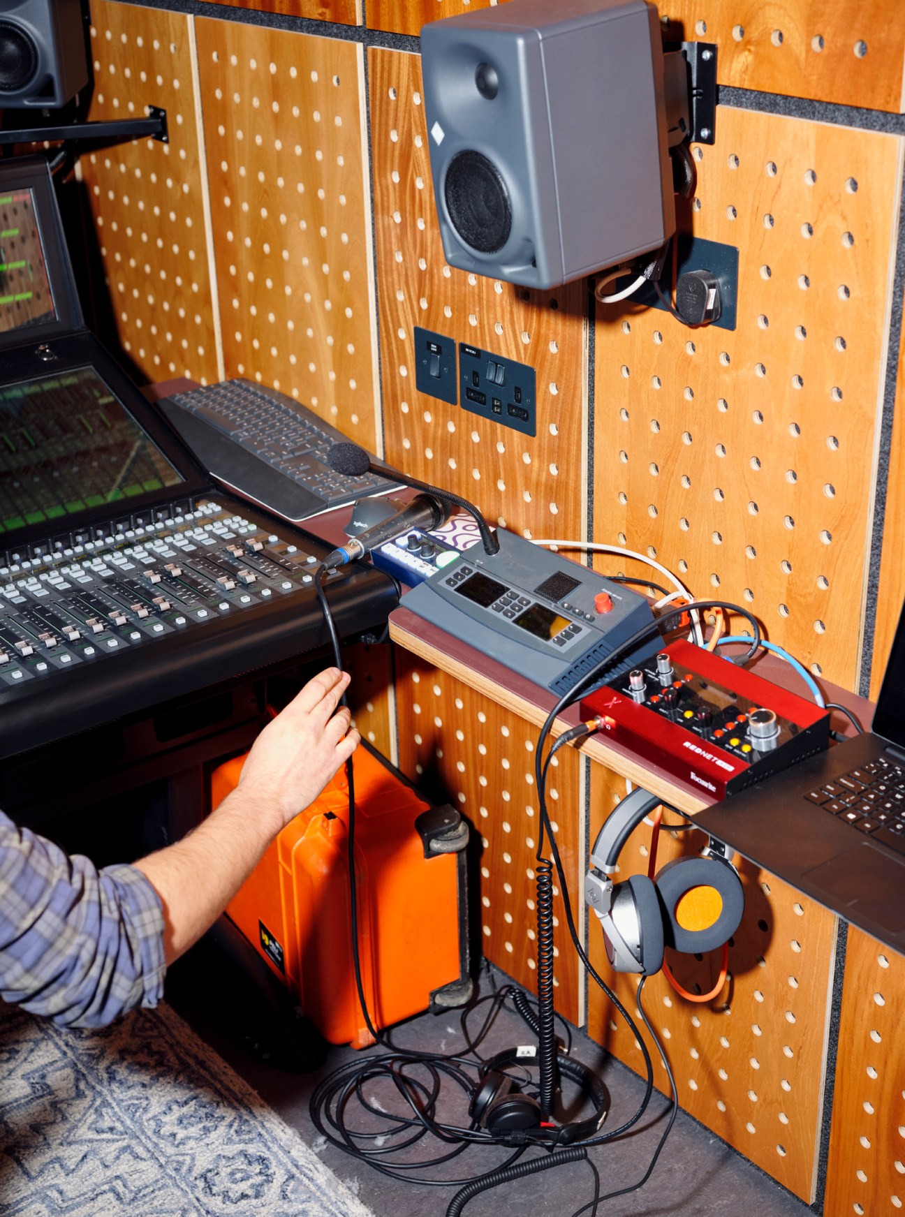 Interior view of Spiritland One broadcast truck showing wood-paneled production space with audio mixing equipment