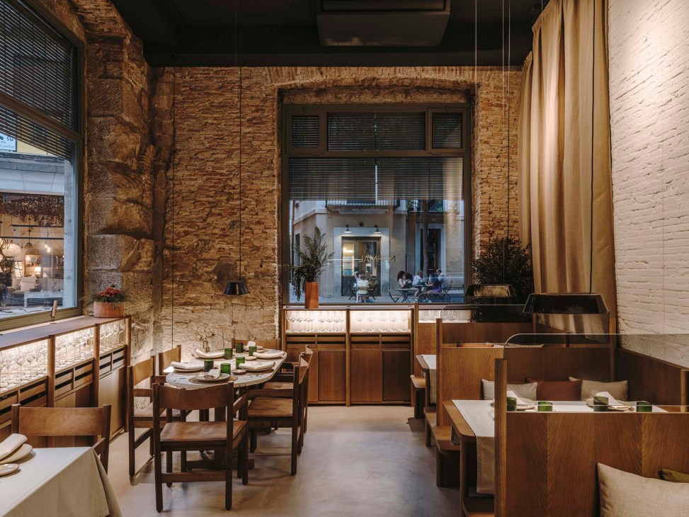 Interior view of Normal restaurant showing one of two dining rooms with wooden tables and exposed brick walls