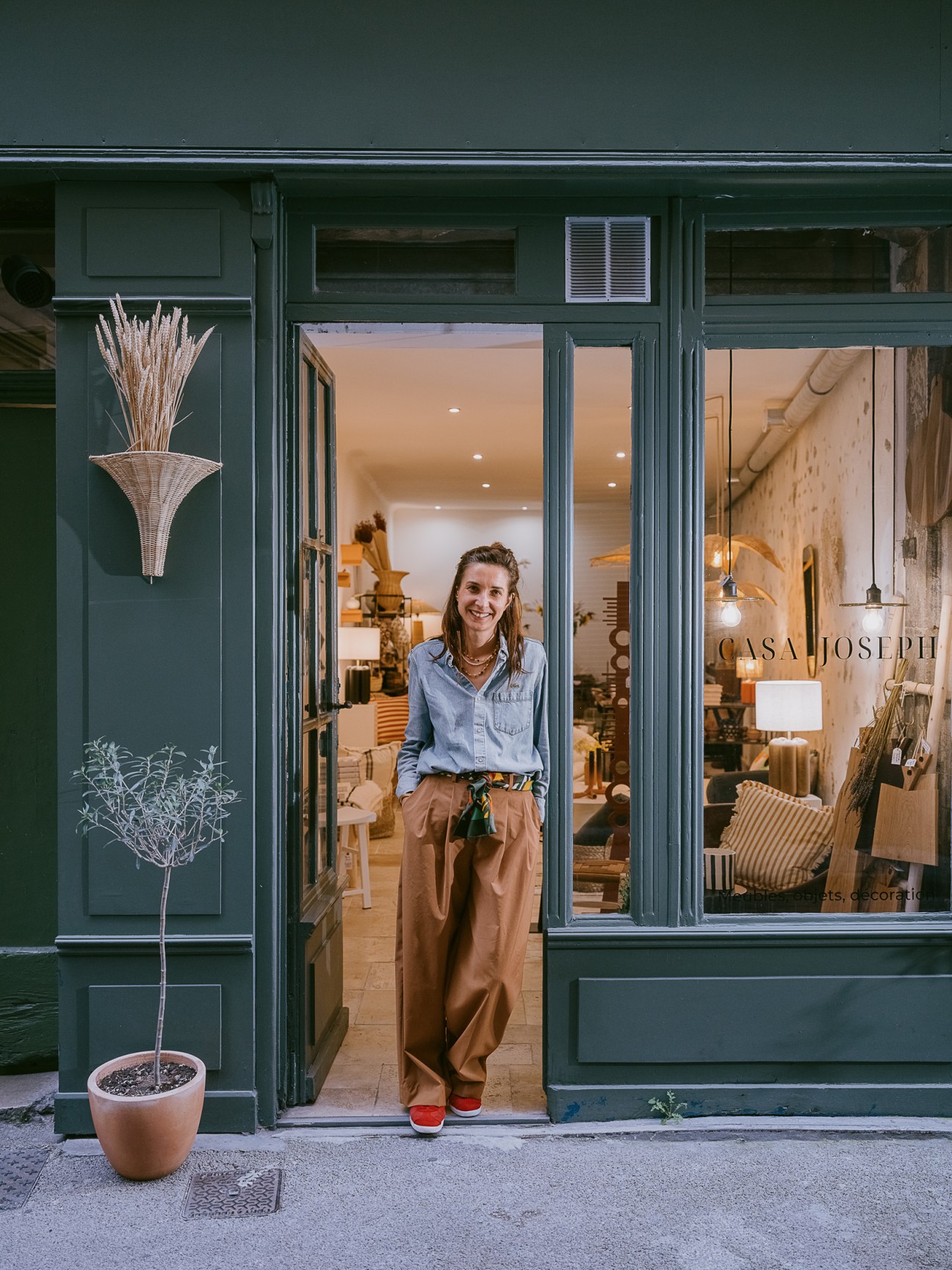 Woman standing in doorway of Casa Joseph homeware shop in Toulon, France