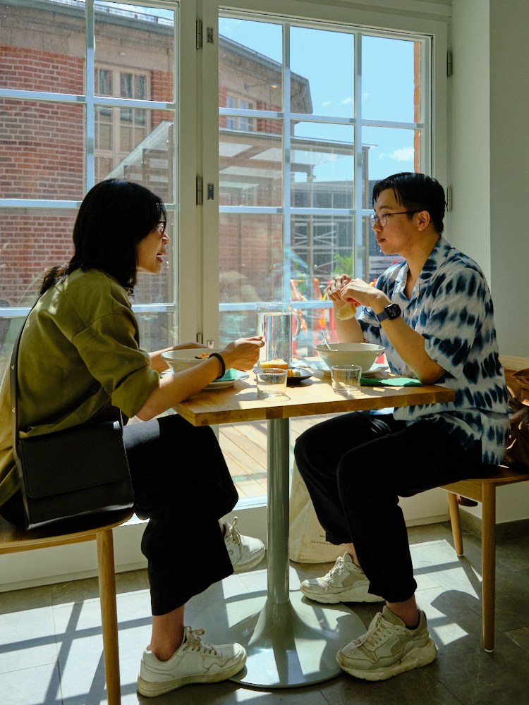 Two people sitting at a table by large windows in Kirsikka restaurant
