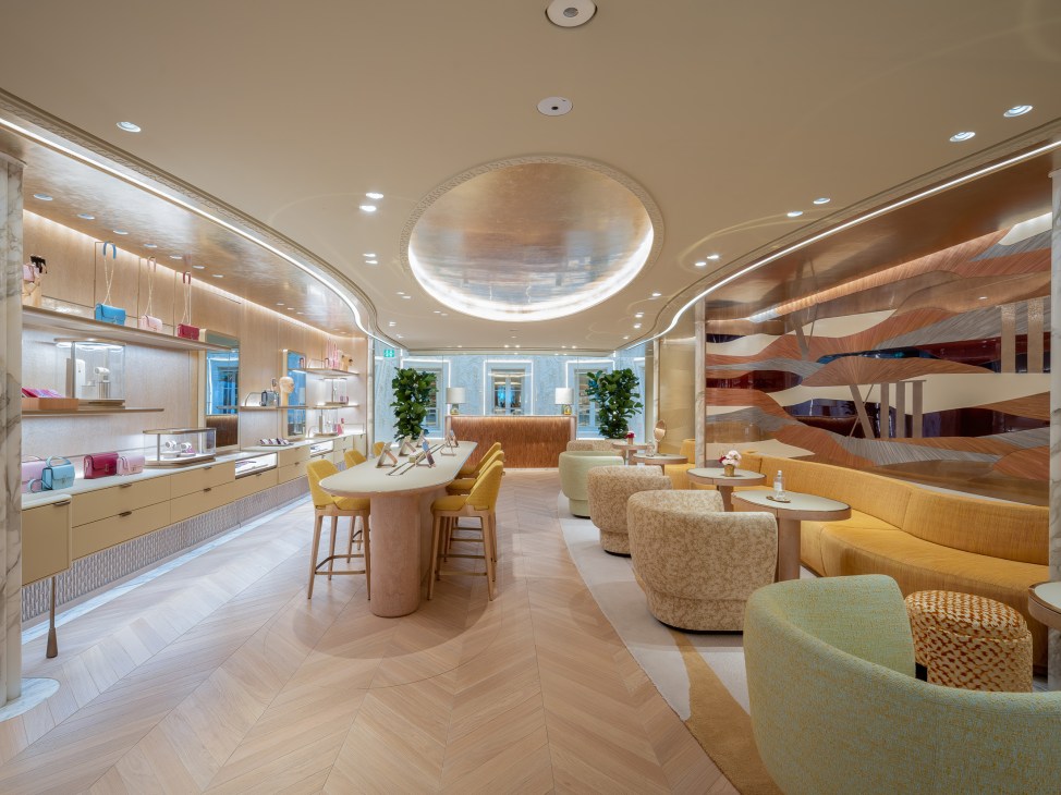 Modern Cartier boutique interior with curved seating, warm lighting, wooden stairs and display cases