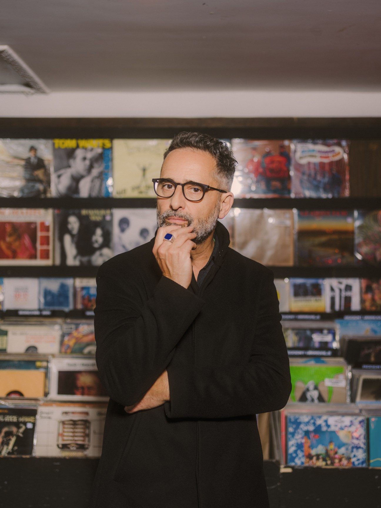 Jorge Drexler browsing vinyl records at Permanent Records in northeast Los Angeles