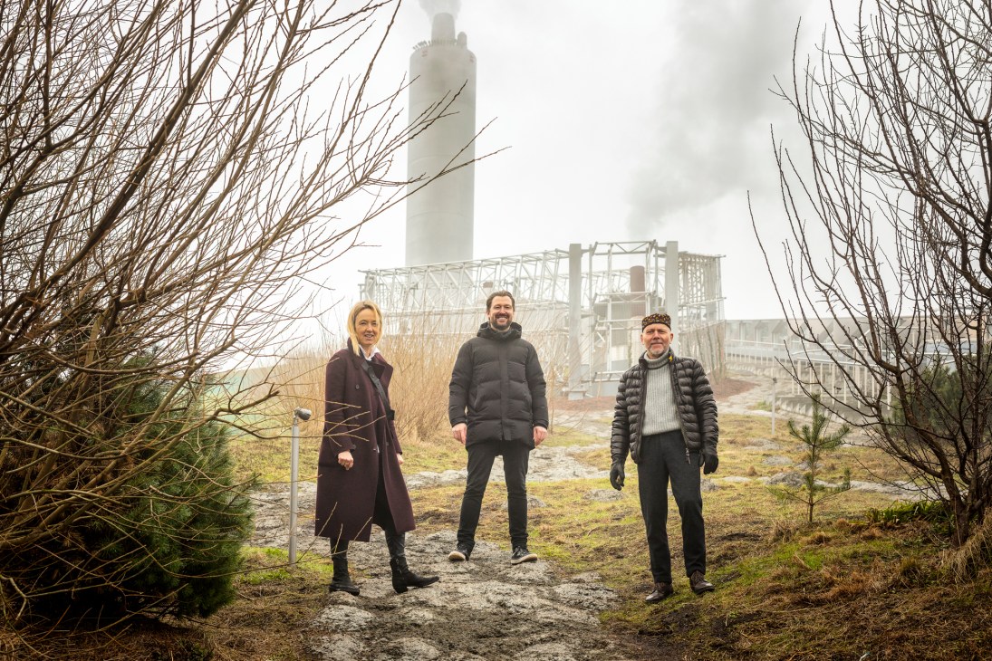 Mette Skjold, Rasmus Astrup and Stig Andersson standing on Copenhill rooftop with industrial structure in background