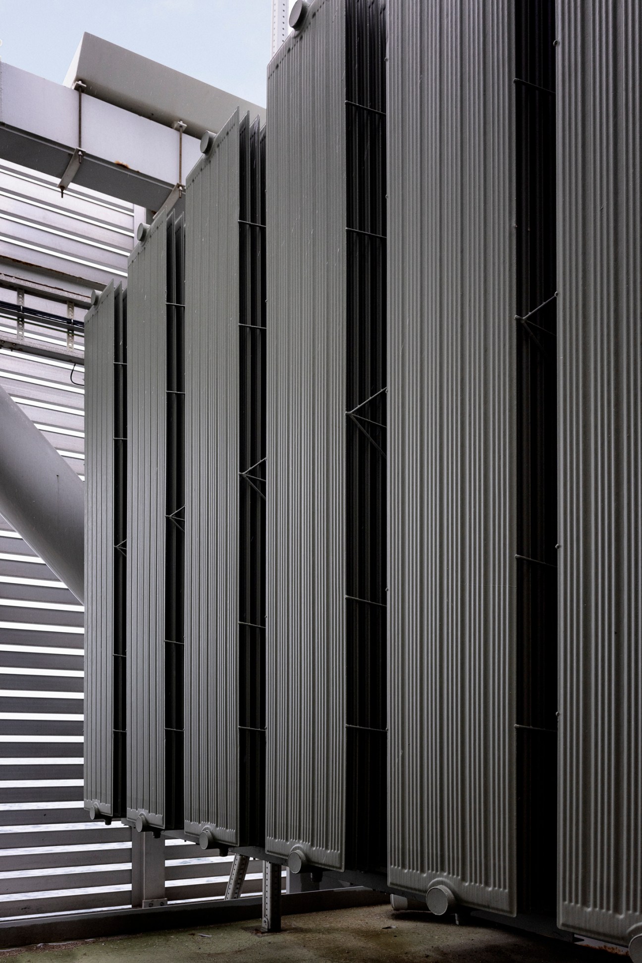 Modern industrial metal container with corrugated steel panels and ventilation grilles.