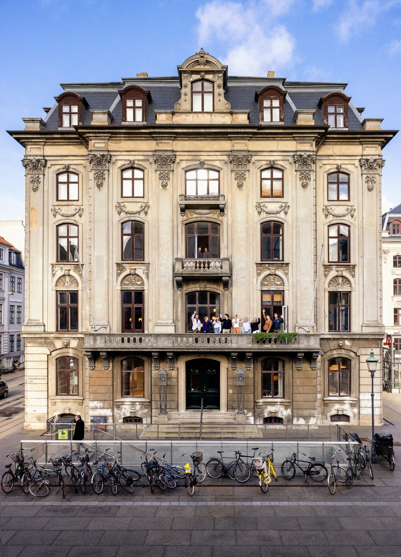 Elegant historic stone building with ornate facade featuring decorative carvings and multiple arched windows