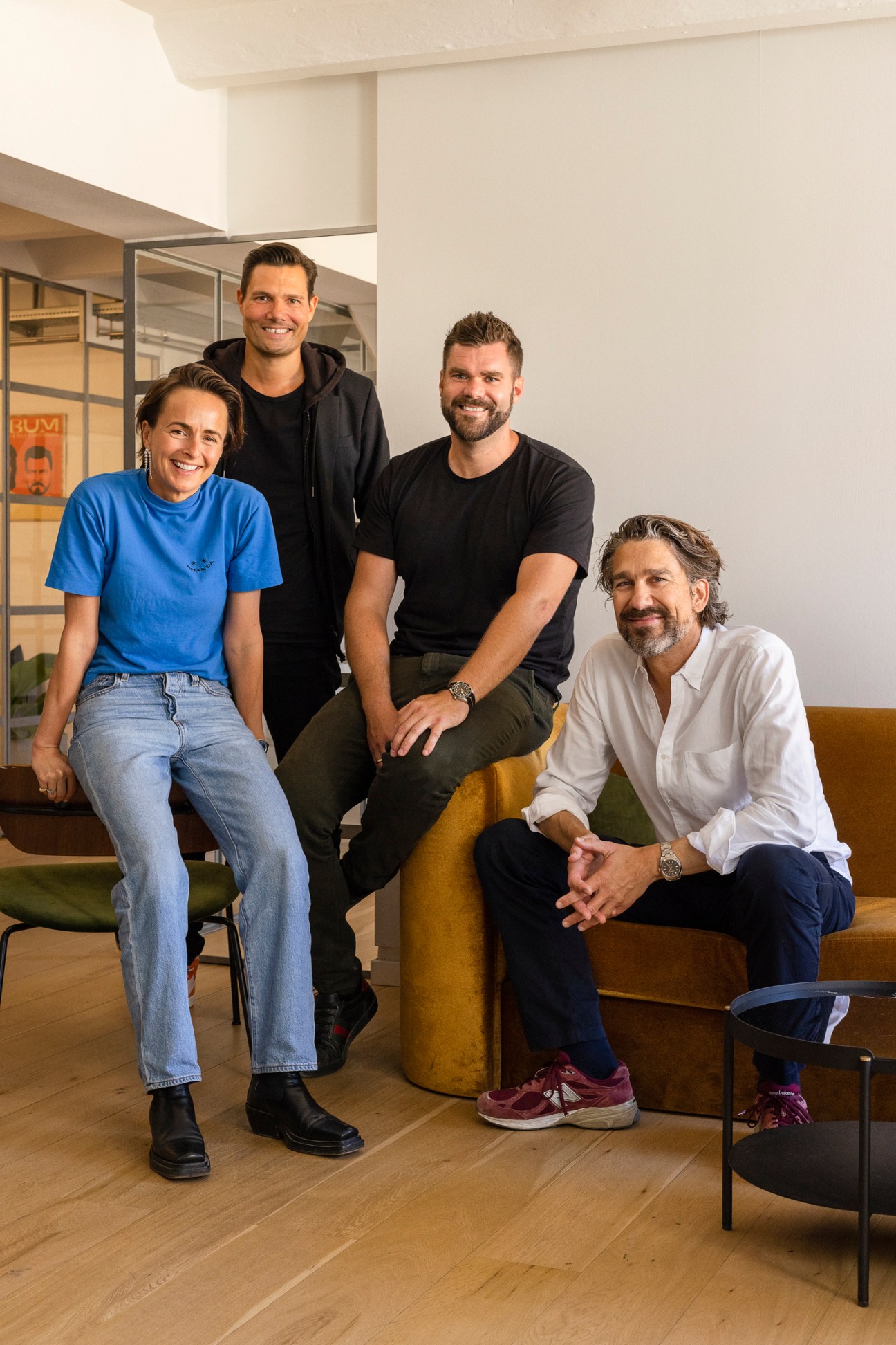 Four Podimo founders pose together in an office: Eva Laegdsgaard, Andreas Sachse, Morten Strunge, and Nikolaj Koppel.
