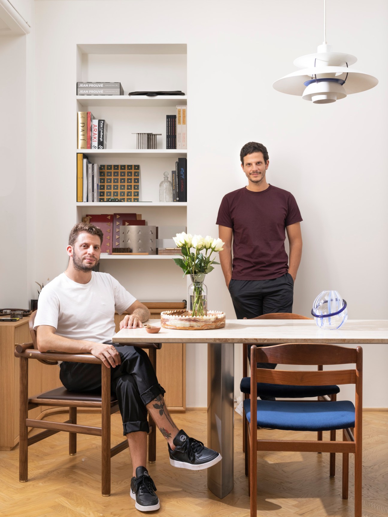 David Raffoul and Nicolas Moussallem in their Milan studio workspace with built-in shelving and modern furniture