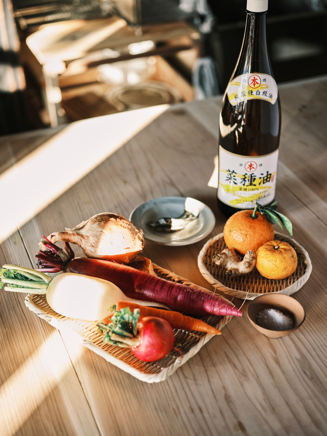 Japanese sake bottle with vegetables, citrus fruits and mushrooms arranged on wooden table