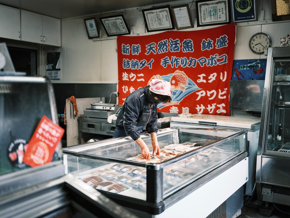 Traditional Japanese fish shop storefront with signage and fresh seafood displays