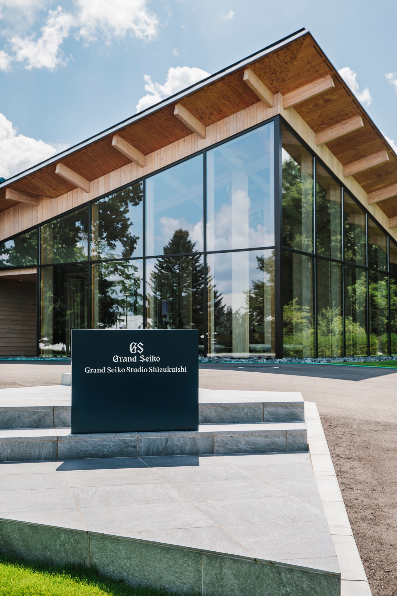 Modern wooden studio building with large glass windows and exposed timber structure designed by Kengo Kuma