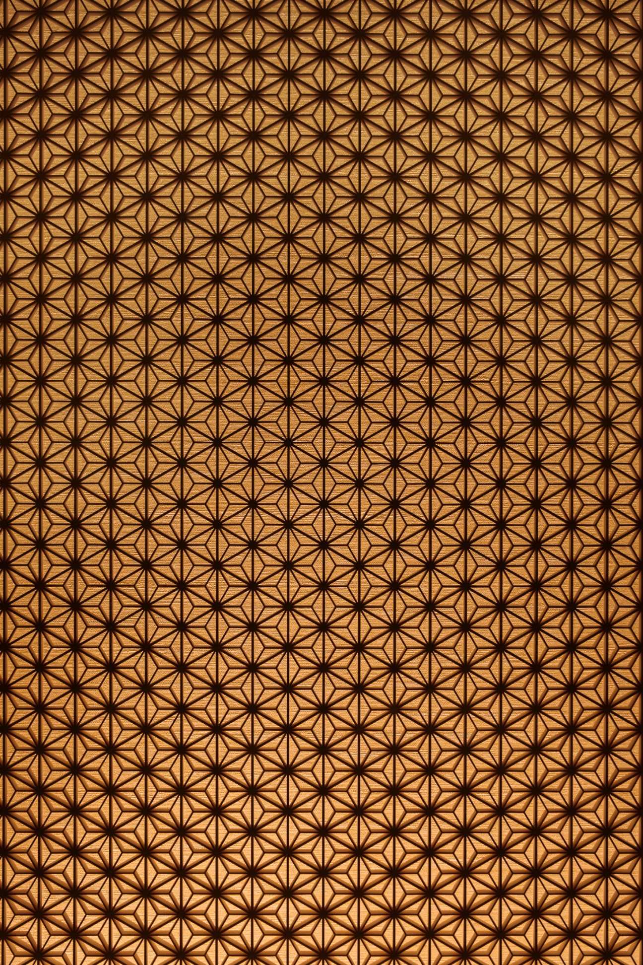 A repeating geometric star pattern in warm brown tones.