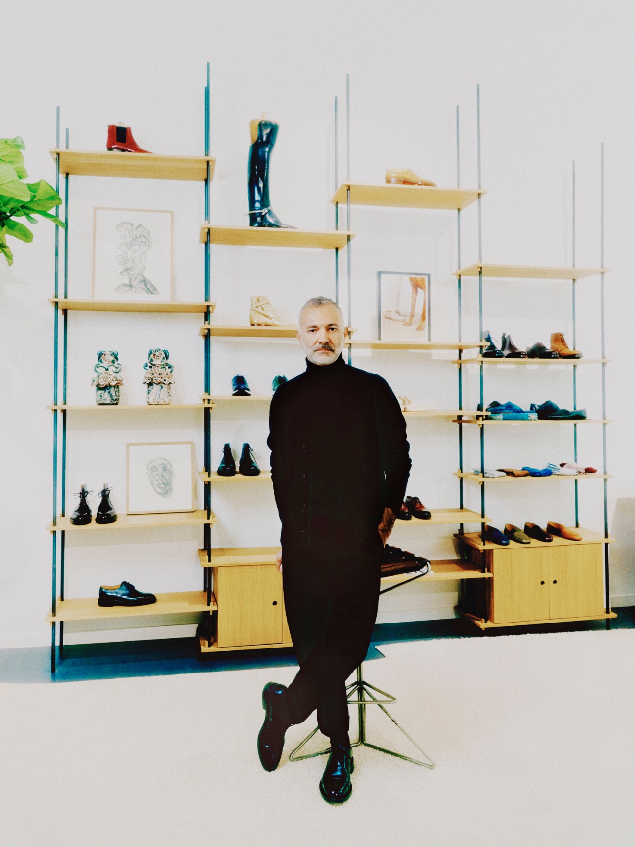 Philippe Gonzalez standing in a showroom with shelves displaying shoes and boots