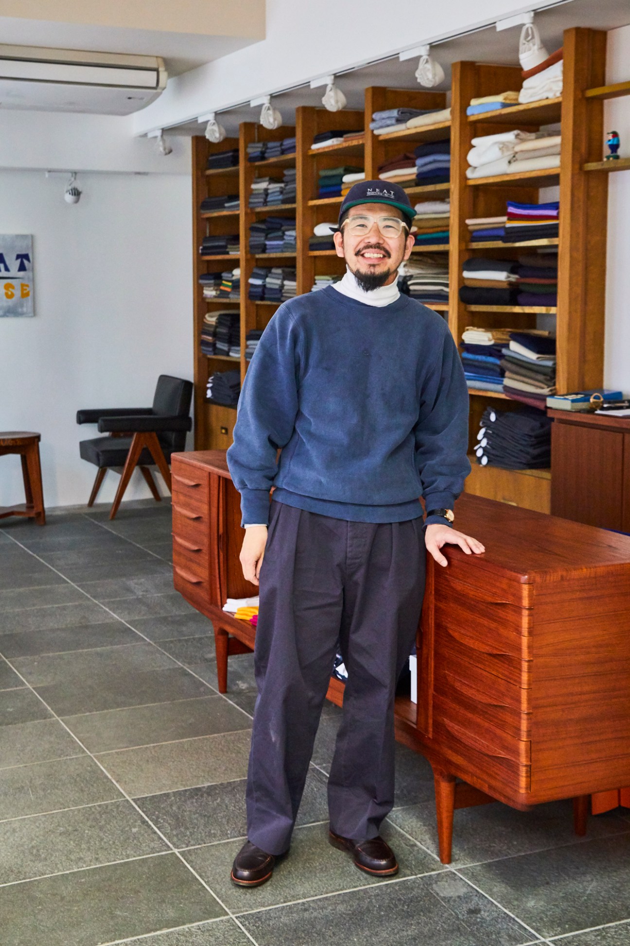Interior of Neat Tokyo showroom displaying bespoke trouser fabrics and samples