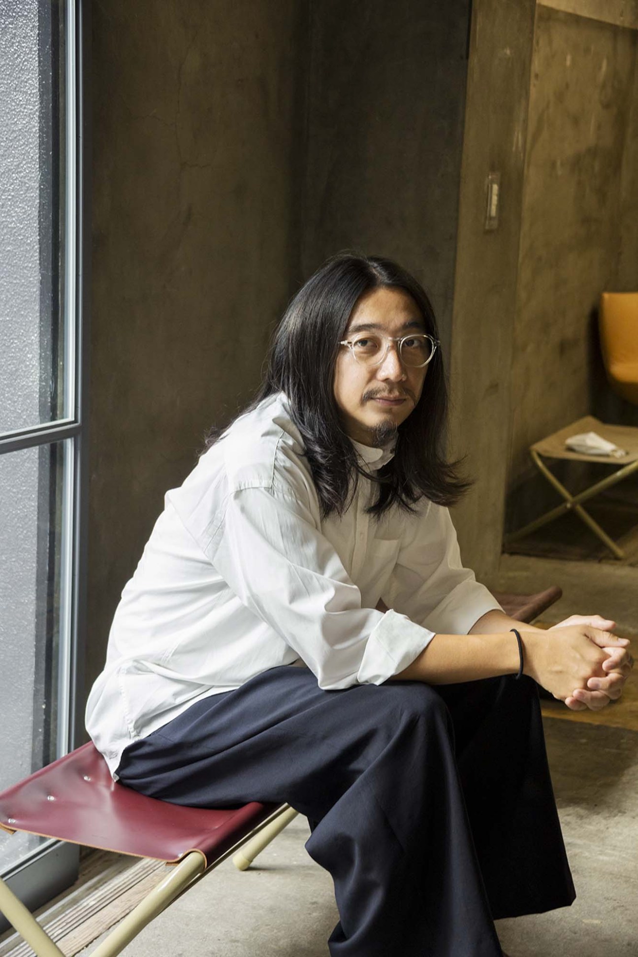 Ryo Kashiwazaki, founder of Hender Scheme, seated in his Tokyo atelier workspace