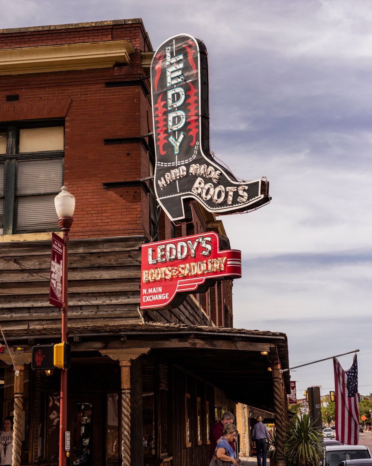 Vintage neon signs for Leddy's boots and saddlery mounted on historic brick building in Fort Worth Stockyards