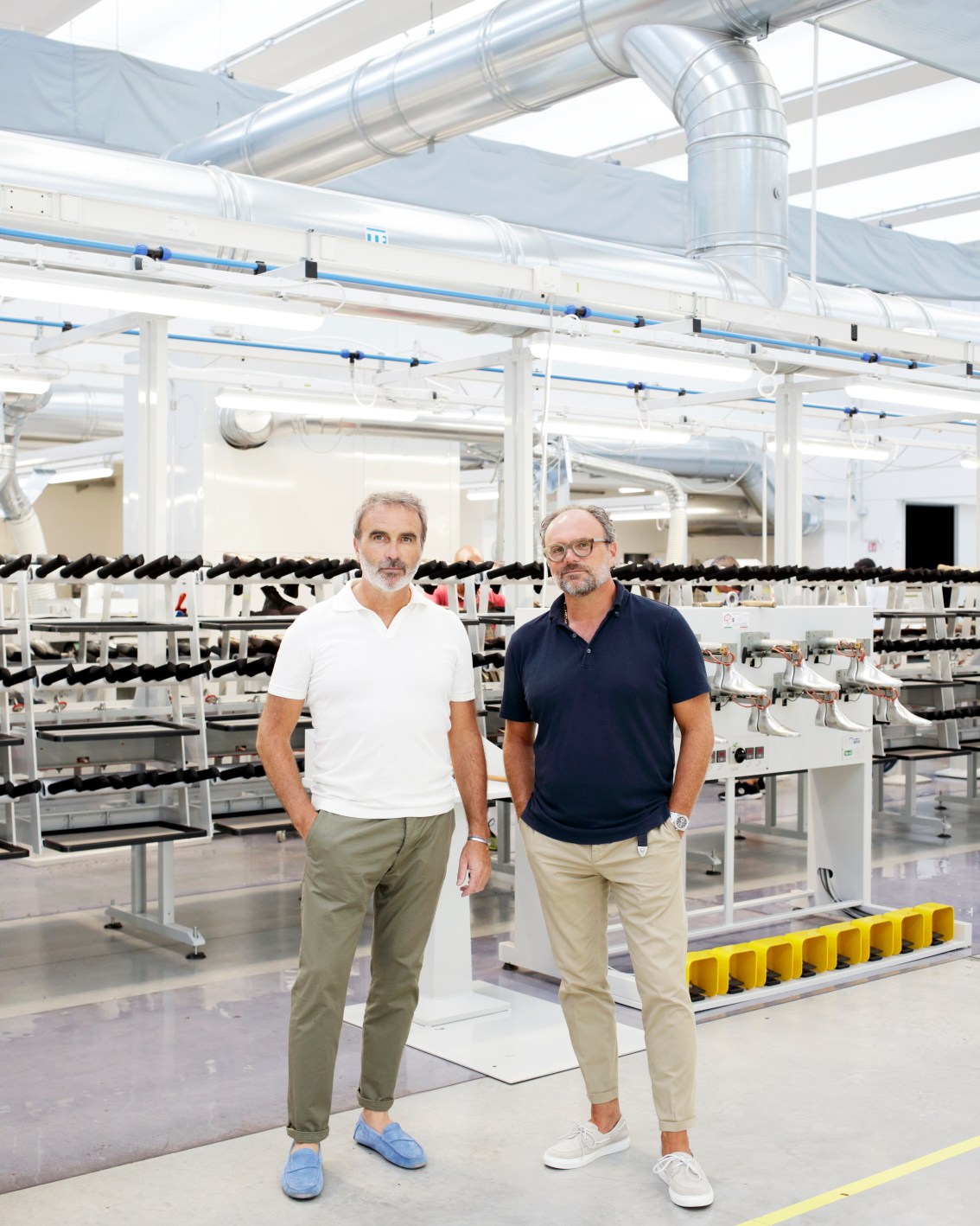 Craftsman working on luxury footwear in Italian shoe factory with tools and materials