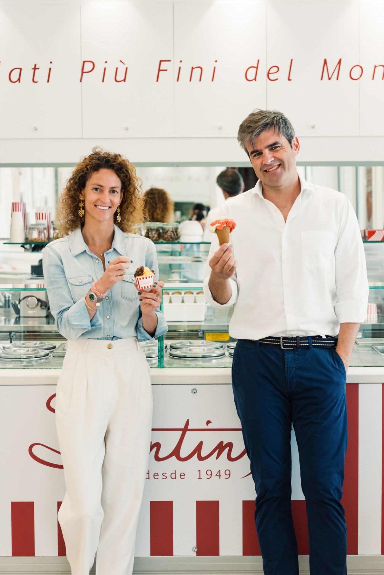 Marta Botton and Eduardo Santini Fuertes, managing partners of Santini, holding gelato at their shop counter.