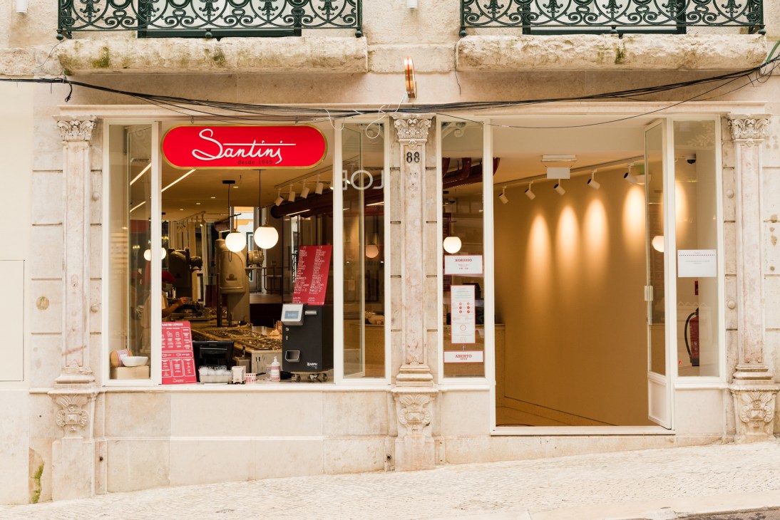 Santini gelato shop storefront in Lisbon with red neon sign and cream-colored facade