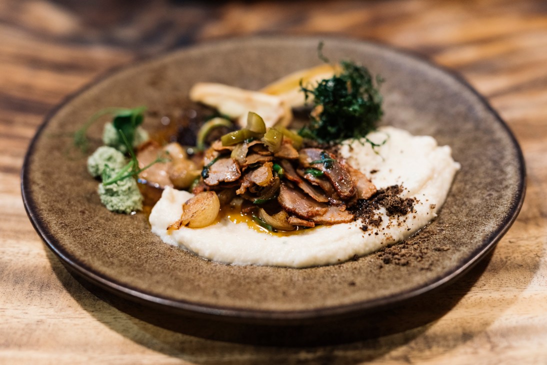 Fine dining dish at Los Locos restaurant with sautéed mushrooms and capers on creamy sauce.