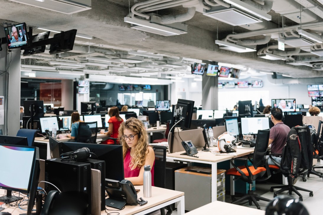 Interior view of Expresso newspaper office with desks and work areas